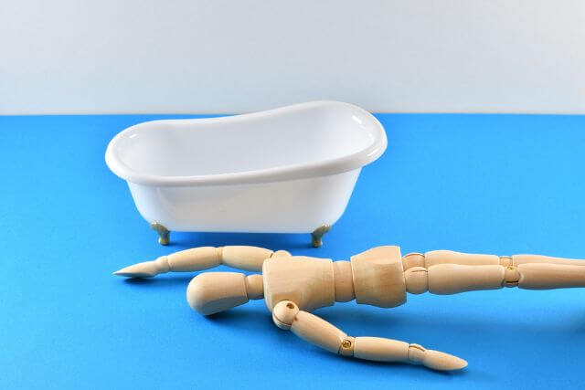 木製マネキンと白い浴槽の静物画